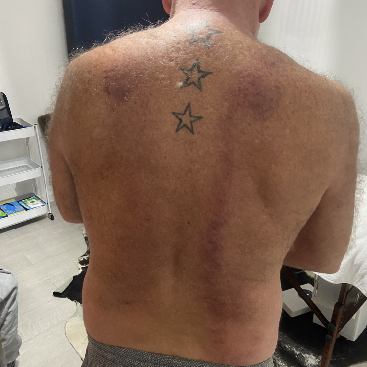 Client stood with his back to the camera in my studio and wearing no tshirt